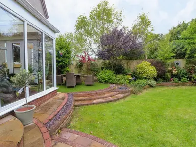 a backyard with a patio and a lawn at Linwood in Thornton