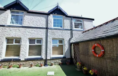 a house with a red lifesaver on the side of it at Sea Breeze Studio @ The Coach House in Saint Annes on the Sea
