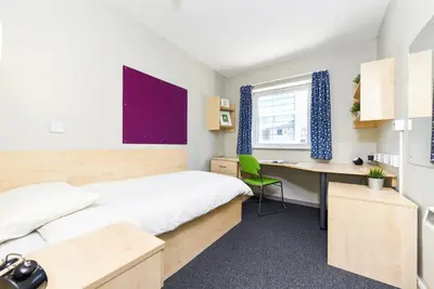 a bedroom with a bed and a desk and a computer at For Students Only - Capital Gate in Liverpool in Liverpool