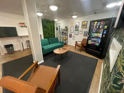 a living room with a couch and a soda machine at For Students Only Apollo Court in Liverpool in Liverpool
