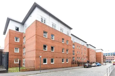 a large red brick building on a city street at For Students Only Apollo Court in Liverpool in Liverpool