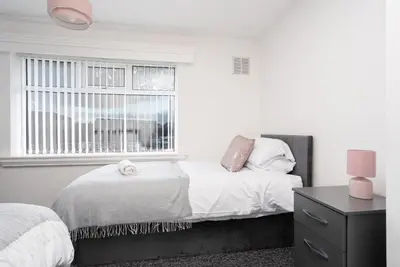 a bedroom with two beds and a window at Large 3 bedroom Liverpool Free parking in Liverpool