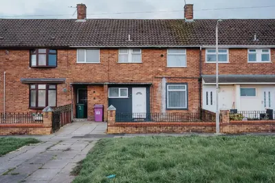 a brick house with a purple door at Large 3 bedroom Liverpool Free parking in Liverpool