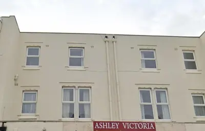 a white building with a sign in front of it at Ashley Victoria in Blackpool
