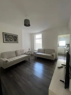 a living room with two couches and a television at No. 10 - Home away from Home in Litherland