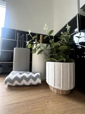 two white vases with plants on a wooden floor at No. 10 - Home away from Home in Litherland
