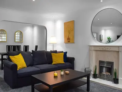 a living room with a couch and a fireplace at West Street House in Southport