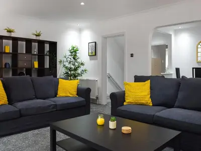 a living room with two couches and a coffee table at West Street House in Southport