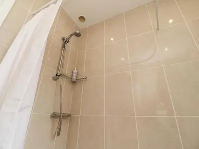 a shower with a shower curtain in a bathroom at 14 Berwick Road in Lytham St Annes