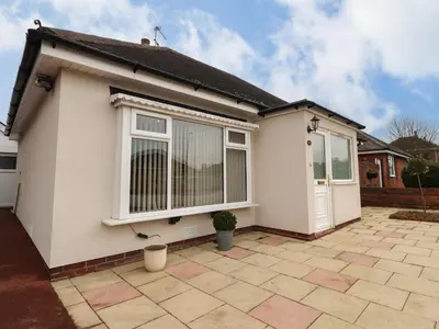 a white house with a door and a patio at 14 Berwick Road in Lytham St Annes