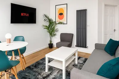 a living room with a couch and a table at Perfect Modern 4 bedroom in Liverpool in Liverpool