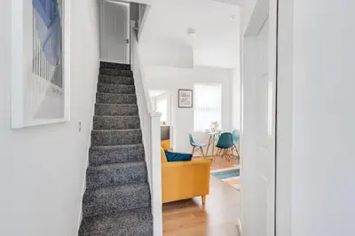 a staircase leading up to a living room and dining room at Perfect Modern 4 bedroom in Liverpool in Liverpool