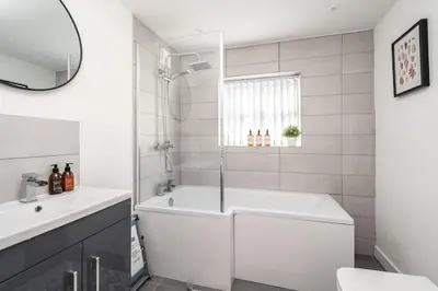 a white bathroom with a tub and a sink at Perfect Modern 4 bedroom in Liverpool in Liverpool