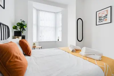 a bedroom with a large bed with two pillows on it at Perfect Modern 4 bedroom in Liverpool in Liverpool