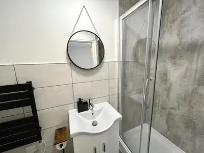 a bathroom with a sink and a mirror at Eden Corner - 2 Bed in Morecambe