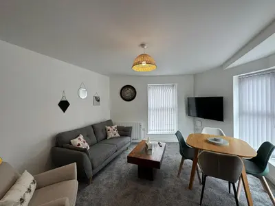 a living room with a couch and a table at Eden Corner - 2 Bed in Morecambe