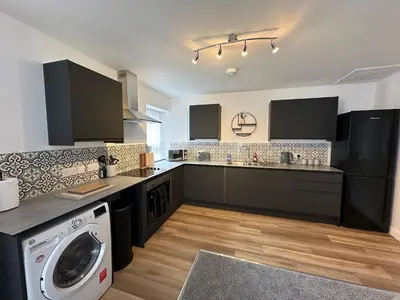 a kitchen with a washer and a washing machine at Eden Corner - 2 Bed in Morecambe