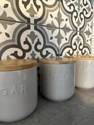a group of three white pots in front of a wall at Eden Corner - 2 Bed in Morecambe