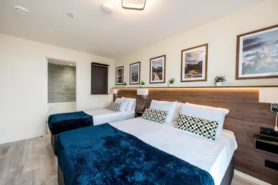 a hotel room with two beds and a tv at Stunning 2 Bed Apartment U6 - Sleeps 8 in Liverpool