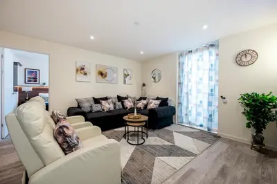 a living room with a couch and a table at Stunning 2 Bed Apartment U6 - Sleeps 8 in Liverpool