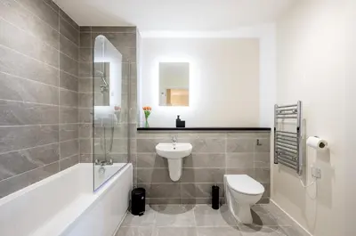 a bathroom with a sink and a toilet and a tub at Stunning 2 Bed Apartment U6 - Sleeps 8 in Liverpool