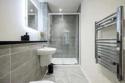 a bathroom with a shower and a toilet and a sink at Stunning 2 Bed Apartment U6 - Sleeps 8 in Liverpool