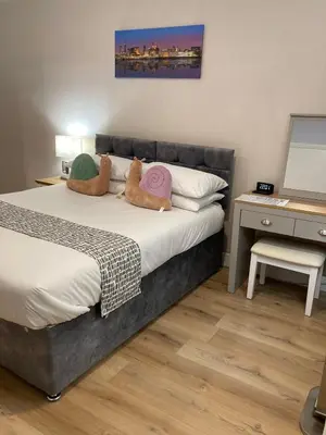 a bedroom with a bed with two pillows on it at Selwyn Stays in Liverpool