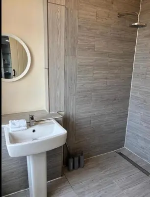 a bathroom with a sink and a shower at Selwyn Stays in Liverpool