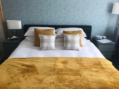 a large bed with white sheets and pillows at Selwyn Stays in Liverpool