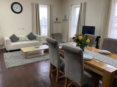 a living room with a dining room table with chairs at Selwyn Stays in Liverpool