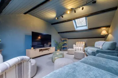 a living room with couches and a flat screen tv at Sunny Brae in Grange Over Sands