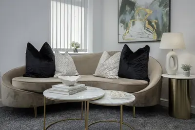 a living room with a couch and two tables at The 1878 by STAMP SA in Blackpool