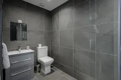 a bathroom with a toilet and a sink at The 1878 by STAMP SA in Blackpool