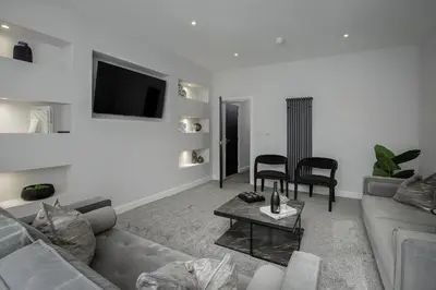 a living room with a couch and a table at The 1878 by STAMP SA in Blackpool