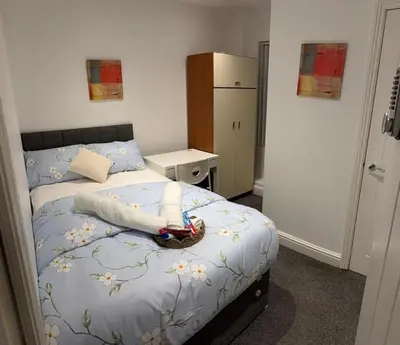 a bedroom with a bed with a basket on it at Beautiful Double Bedroom in Liverpool