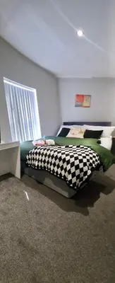 a bedroom with a checkered bed in a room at Beautiful Double Bedroom in Liverpool