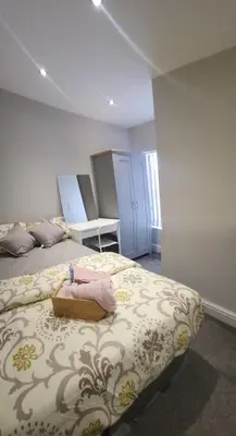 a bedroom with a bed with a purse on it at Lovely Double Bedroom in Liverpool