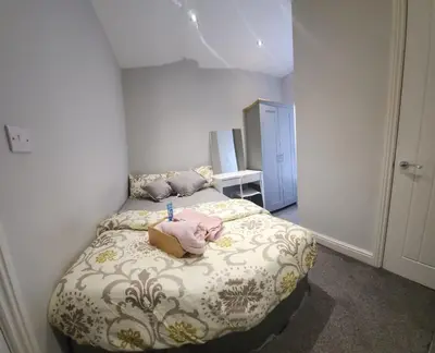 a bedroom with a bed with a stuffed animal on it at Lovely Double Bedroom in Liverpool