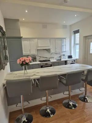 a kitchen with a counter with a vase of flowers on it at Luxury Town House in Blackpool
