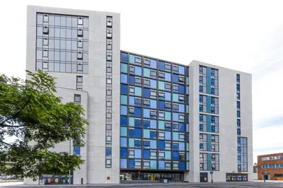 a tall white building with blue windows at For Students Only Byrom Point in Liverpool in Liverpool