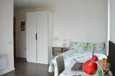 a bedroom with a bed with a laptop on a desk at For Students Only Byrom Point in Liverpool in Liverpool