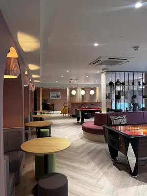 a hotel lobby with tables and couches and a pool table at For Students Only Byrom Point in Liverpool in Liverpool