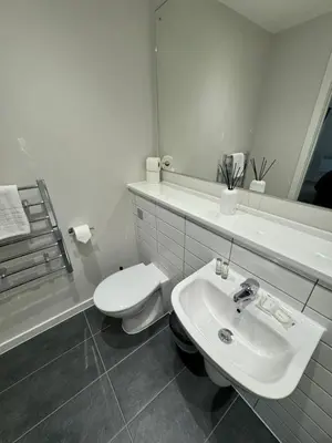 a white bathroom with a toilet and a sink at Richmond Row by L3 Apartments in Liverpool