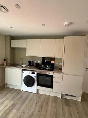 a kitchen with white cabinets and a dishwasher at Richmond Row by L3 Apartments in Liverpool