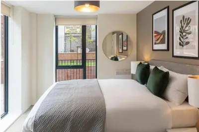 a bedroom with a large bed and a window at Richmond Row by L3 Apartments in Liverpool
