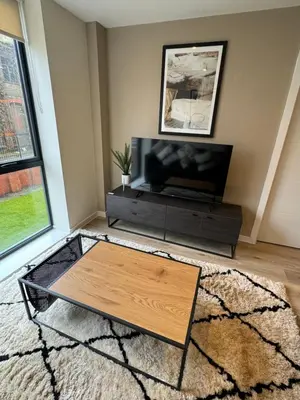 a living room with a tv and a coffee table at Richmond Row by L3 Apartments in Liverpool