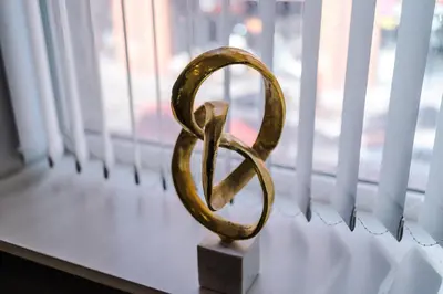 a gold symbol sitting on a window sill at The Seven Suites Liverpool in Liverpool