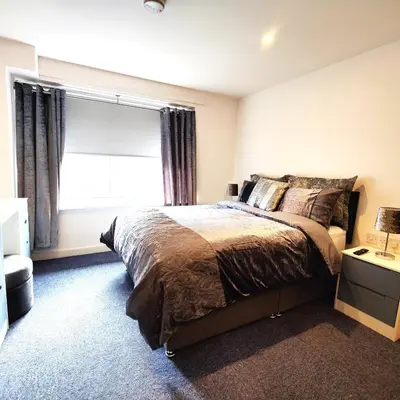 a bedroom with a large bed and a window at Liverpool Stays - Kempston Court in Liverpool