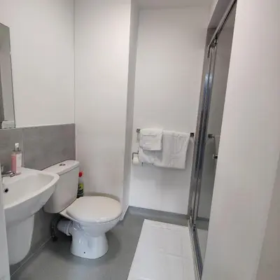 a white bathroom with a toilet and a sink at Liverpool Stays - Kempston Court in Liverpool