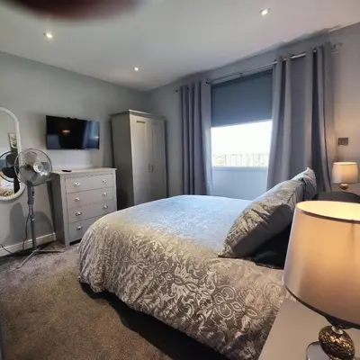 a bedroom with a bed with a dresser and a window at Liverpool Stays - Kempston Court in Liverpool